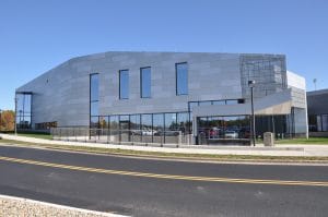 Metal building with windows next to road.